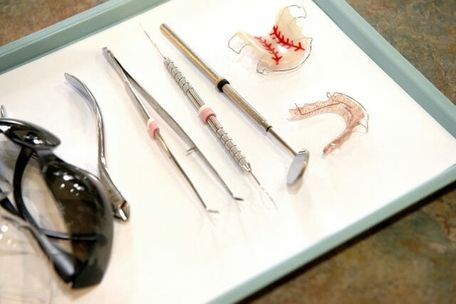 Dental instruments next to retainers