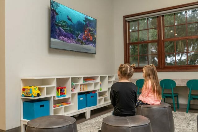 Children sitting in playroom lobby